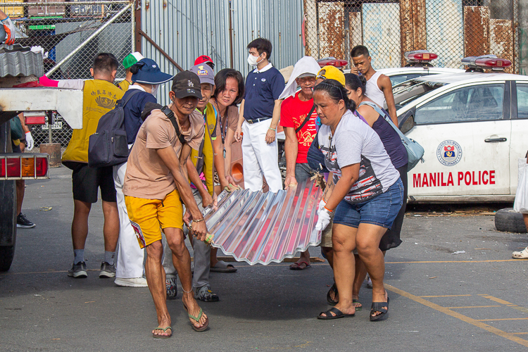 The culture of bayanihan (community spirit) was evident during the distribution of GI sheets. 【Photo by Marella Saldonido】