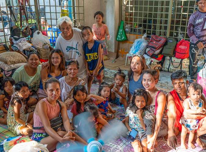 Beneficiary Corazon Baleña (with glasses on her head) and her family currently reside at the Leonardo Fugoso Sport Complex while rebuilding their home in Isla Puting Bato. 【Photo by Harold Alzaga】