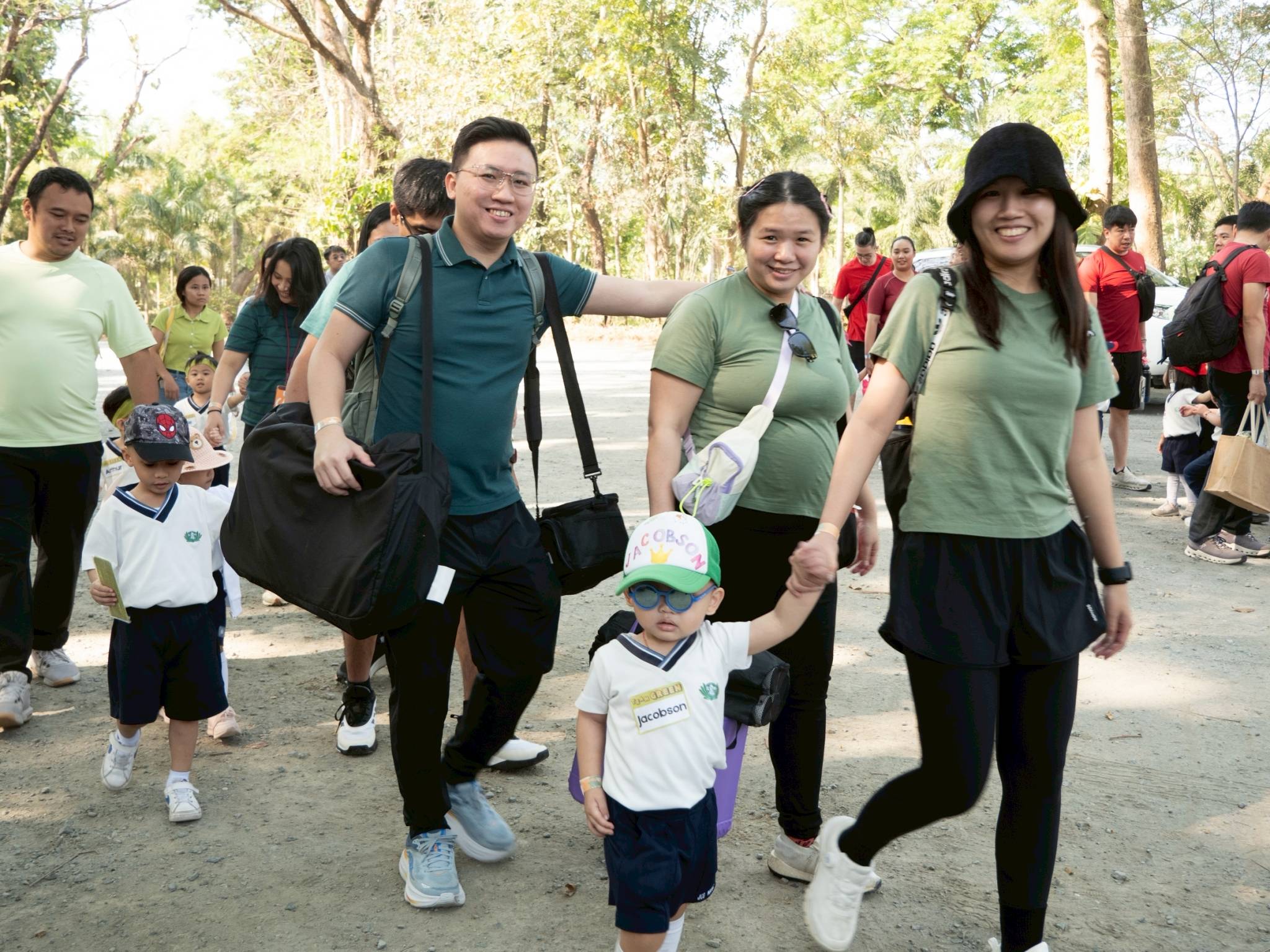 Two-year-old Jacobson Wang (front) arrives with his parents at the Family Sportsfest at Fun Farm.