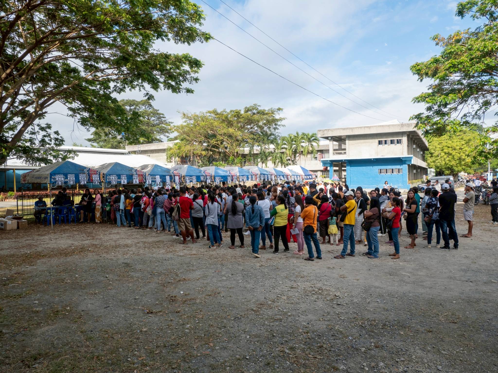 Beneficiaries of Typhoon Basyang patiently line up for the registration process ahead of the relief distribution.