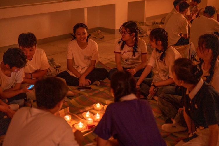 Just before bedtime, participants enjoy a sharing session in an intimate candle-lit setting in the popular activity, “Starry, Starry Night.”