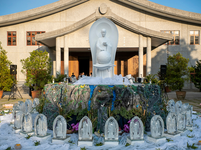 Surrounded by crystal Buddhas, the centerpiece of this year’s 3-in-1 celebration features a breathtaking image of Buddha atop a highly detailed scale model of Vulture Peak.