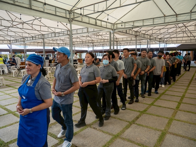Tzu Chi staffers from different departments line up for their turn to strike the gong.