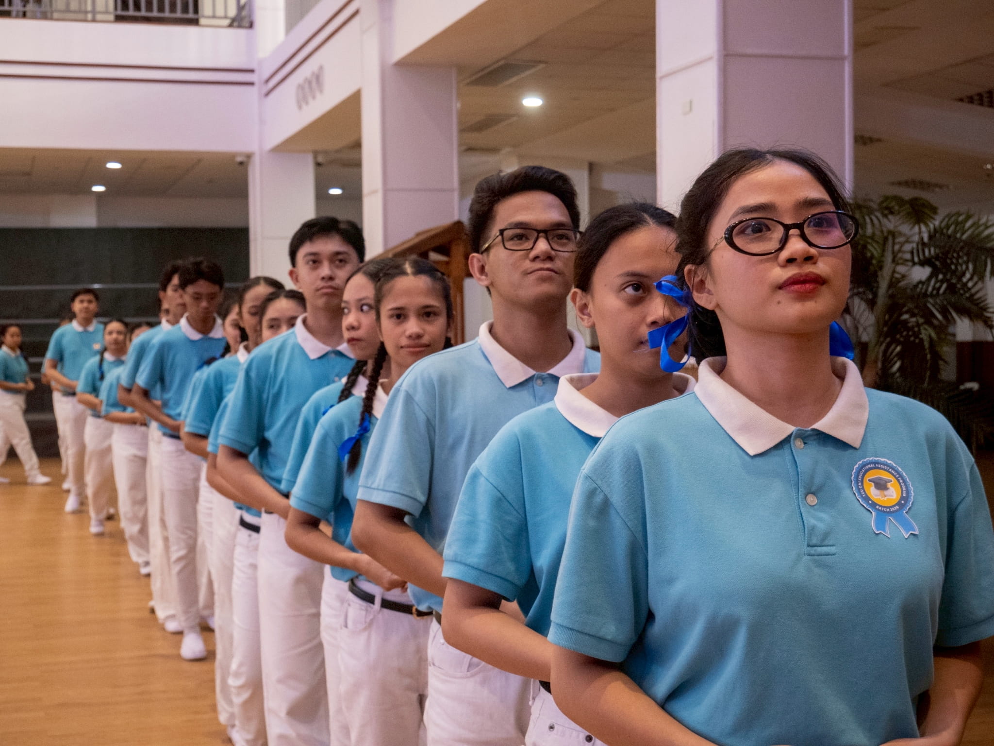 Graduating scholars prepare to go on stage to receive their certificate.