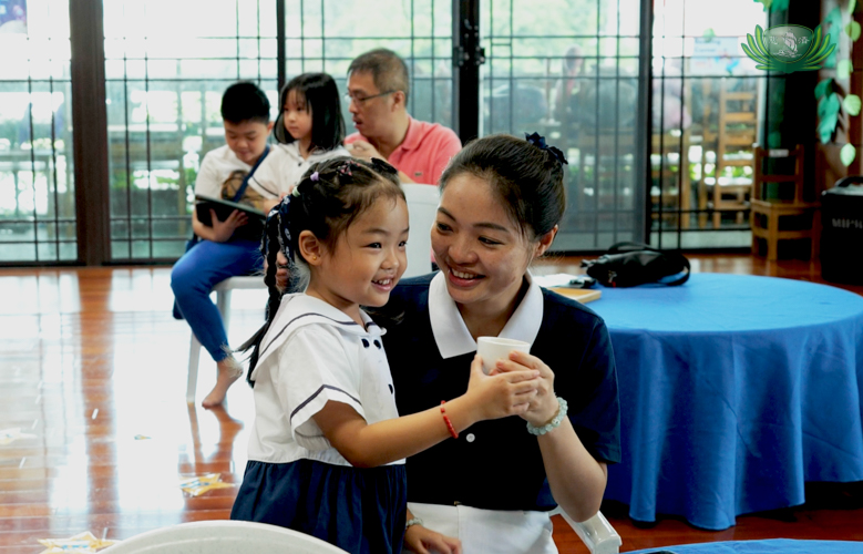 Mother and daughter share smiles during the tea ceremony.