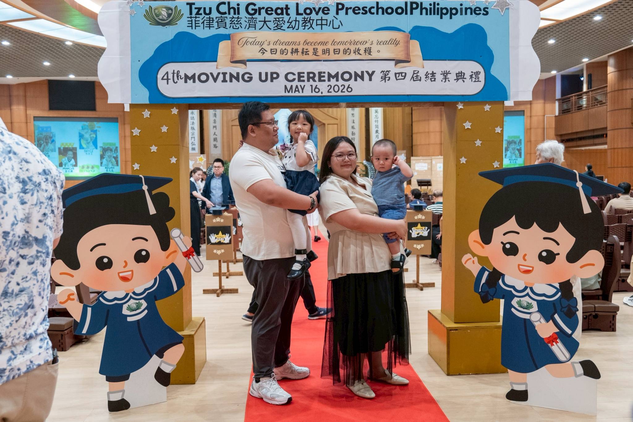 Families pose for pictures before the start of the Moving Up Ceremony.