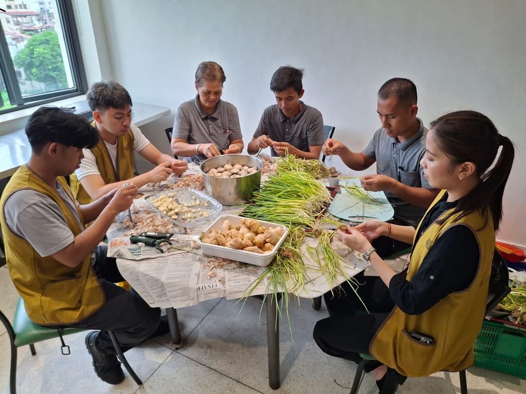 Staffers prepare ingredients for arroz caldo a day before the event.