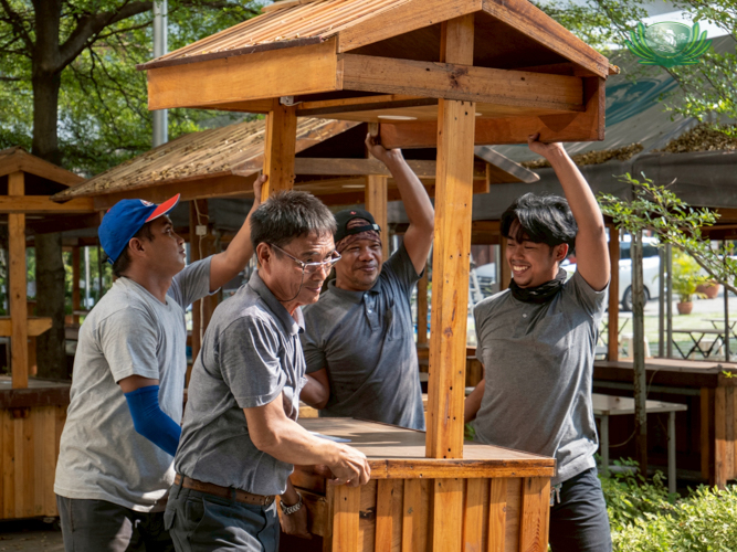 Putting Fiesta Verde together involves a lot of planning. It’s also labor intensive. Here, it takes at least four Tzu Chi staffers to lift and position booths for vendors selling cooked meals at the Plaza. 