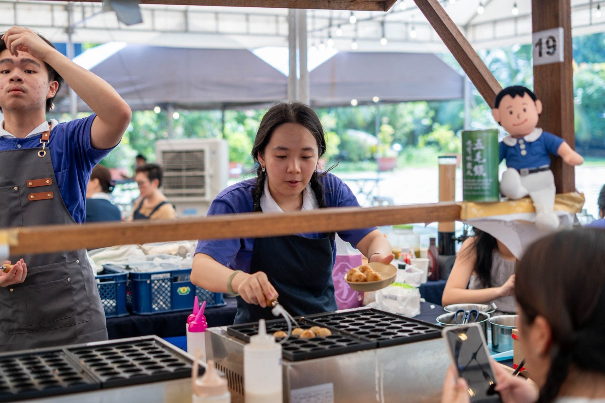 Tzu Chi Youth Emmie Hong leads their booth during Day 2 of the food bazaar.
