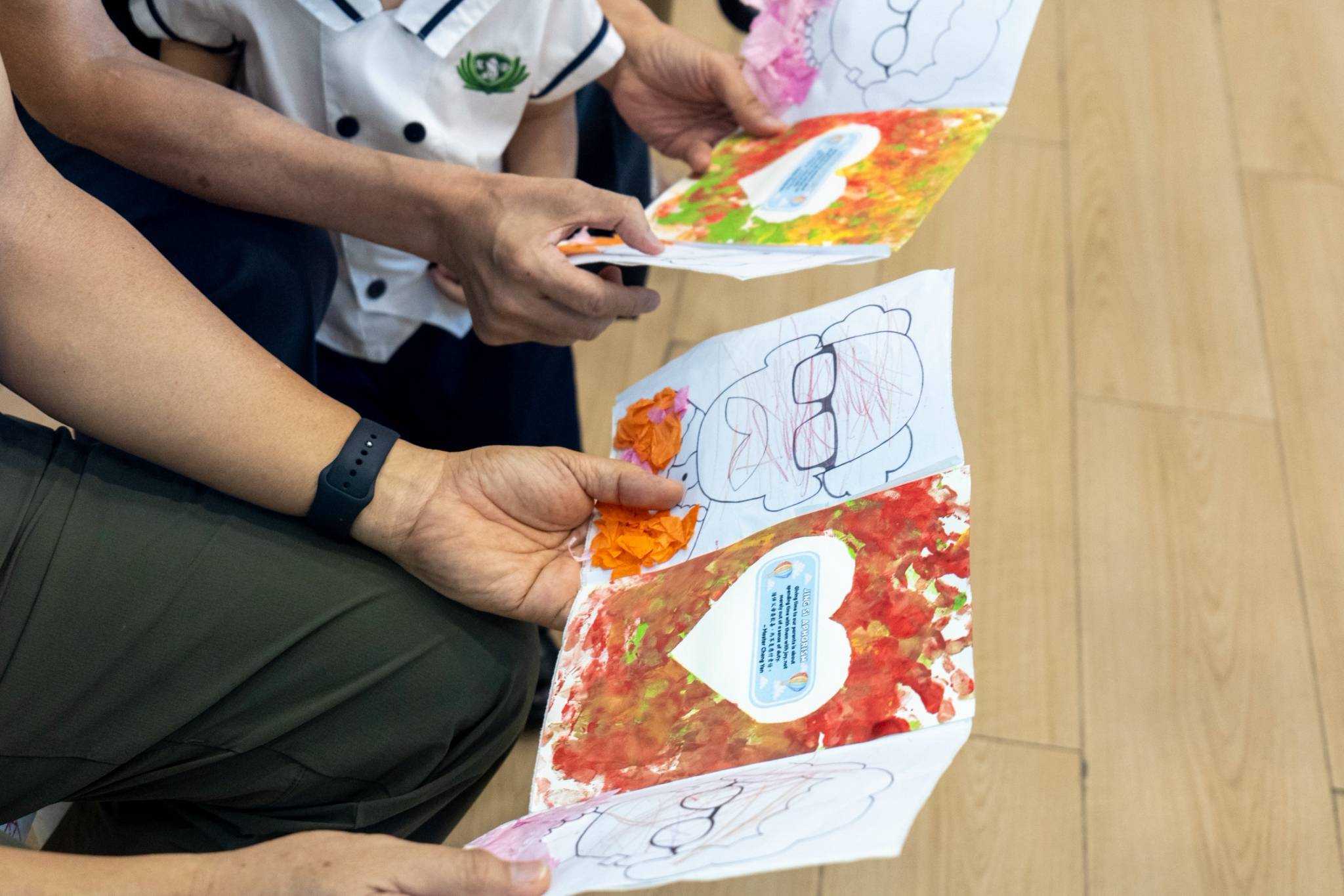 A closer look at the handmade cards created with love shows the young learners personally colored and decorated each drawing with colorful paper cutouts.