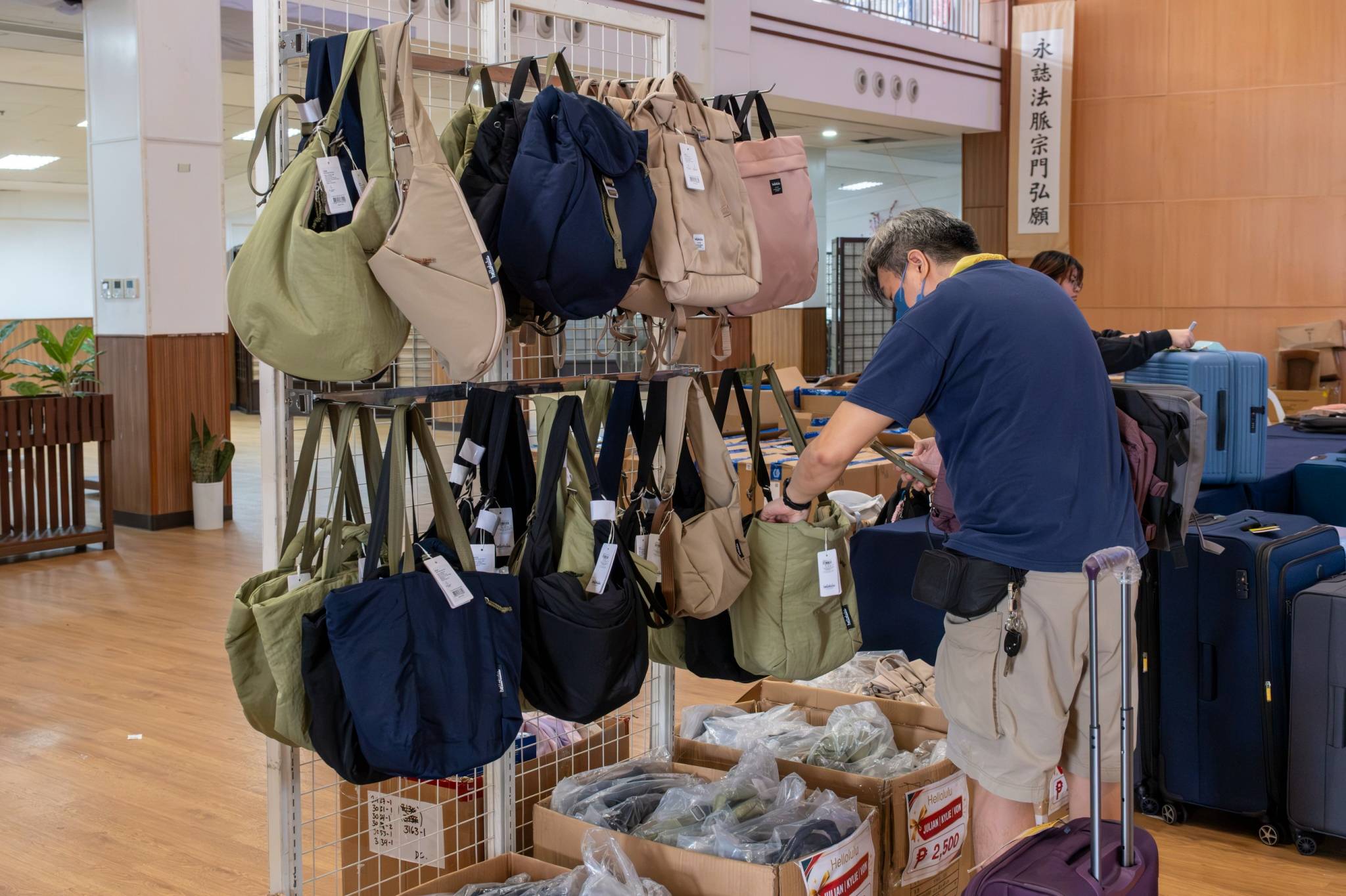 Stylish bags from Hellolulu and Jansport are neatly displayed for shoppers to explore.