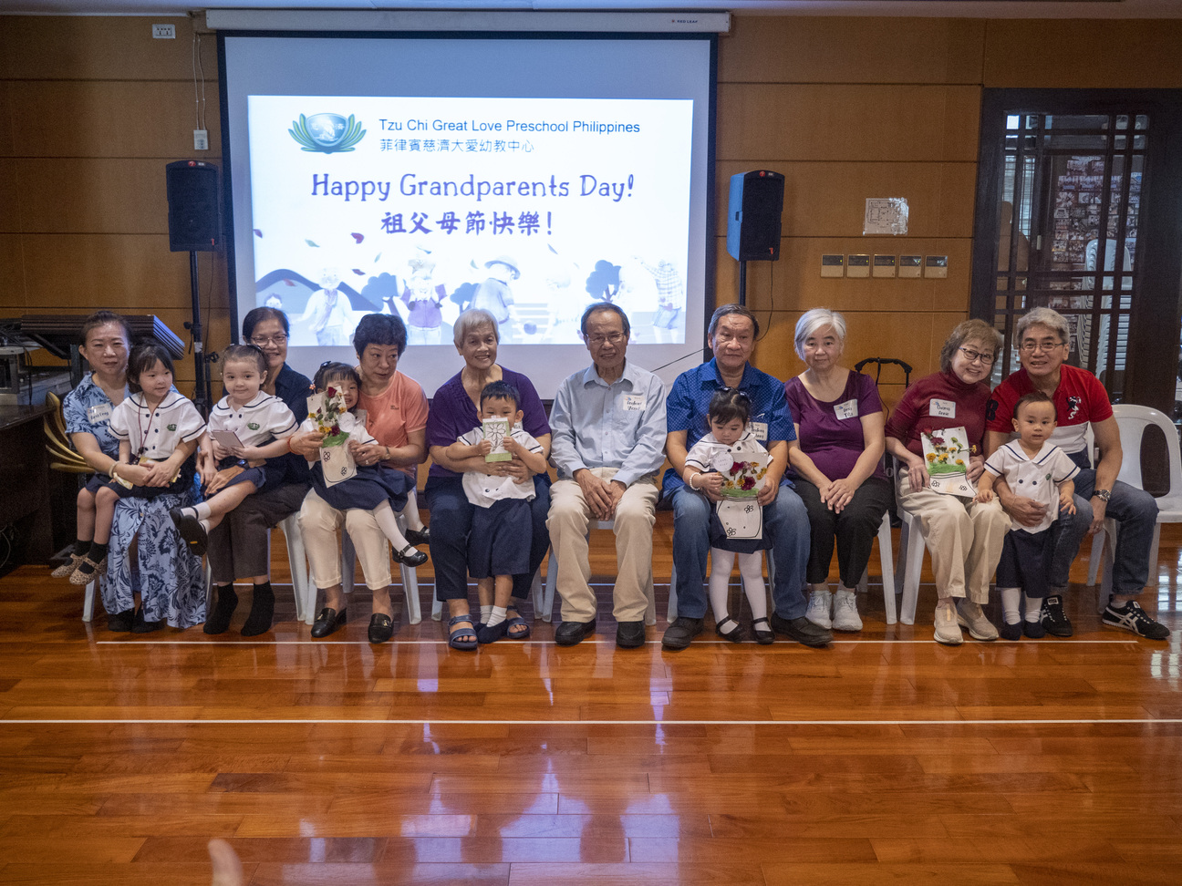 Grandparents happily take a photo together after receiving handmade gifts.