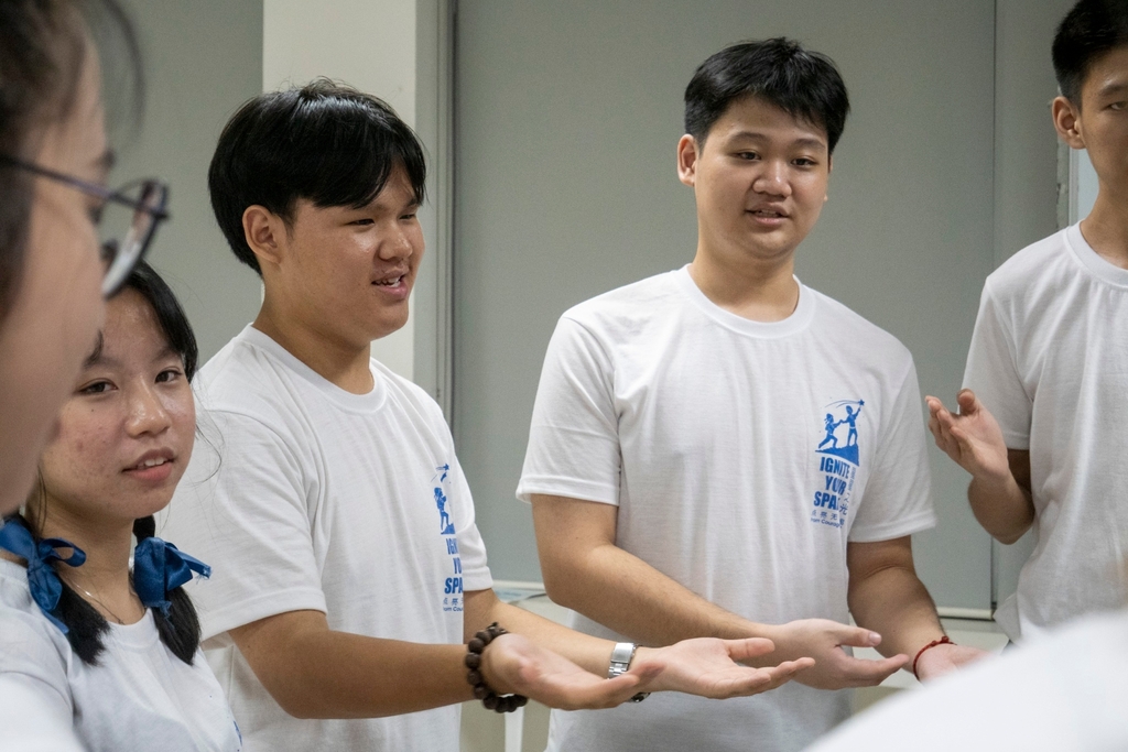 John Carlo Caedo (left) enthusiastically participates in learning a sign language performance.