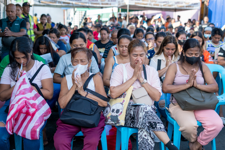 Fire victims pray for a world free from disaster. 