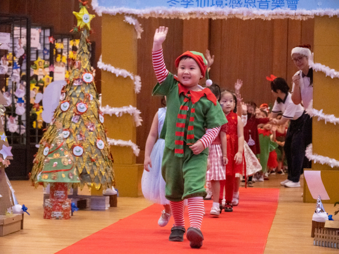 Students happily walk the red carpet, showing off their best costumes.