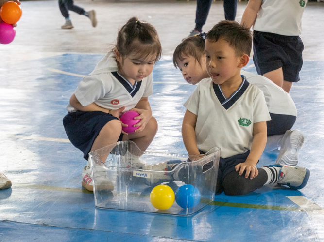 Students take turns in playing a game of shoot-the-ball, as part of their first relay game.