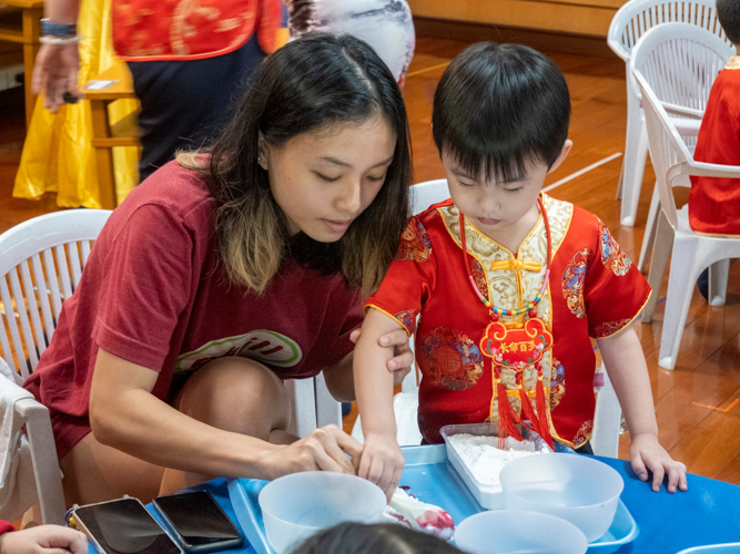 Creating glutinous rice balls (tang yuan) was an activity that encouraged a preschooler to participate and bond with his parents. The sticky balls are a symbol of prosperity and strong family ties. 