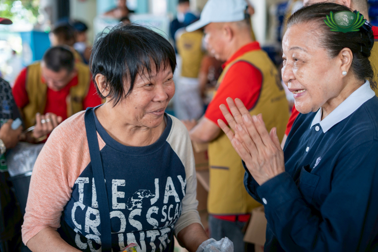 Volunteers thank beneficiaries as they receive relief.