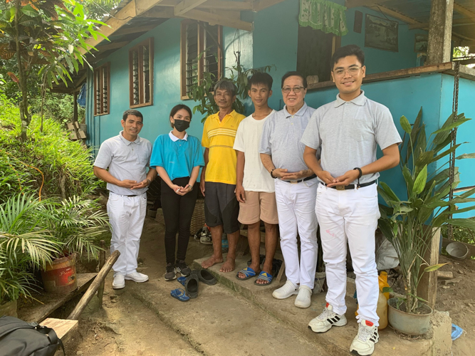 Going the extra-mile: Andrea Bonife Ibañez (in blue) and Tzu Chi volunteers Dhing Abdulaip, Eugene Tan, and Jerome Del Mundo trek uphill to reach families in remote mountain communities, leaving no one behind in their mission of service.