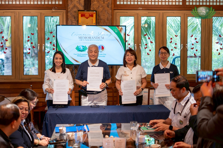 Tzu Chi Foundation Philippines CEO Henry Yuñez (second from left) leads the signing of a Memorandum of Understanding between Tzu Chi Foundation Philippines and Quezon City University.