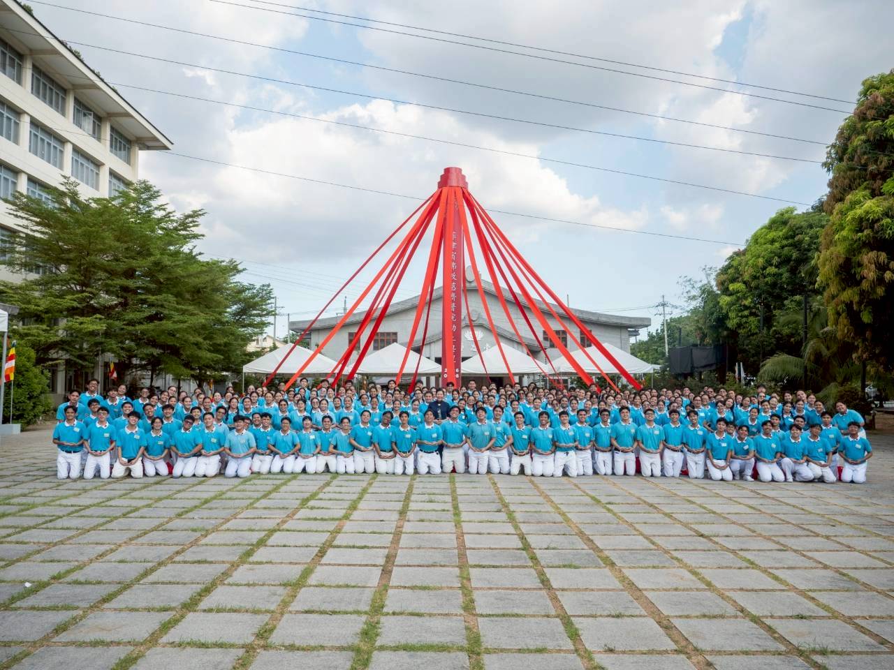Tzu Chi scholars pose for a photo before the groundbreaking marker for the Tzu Chi Medical Center. 