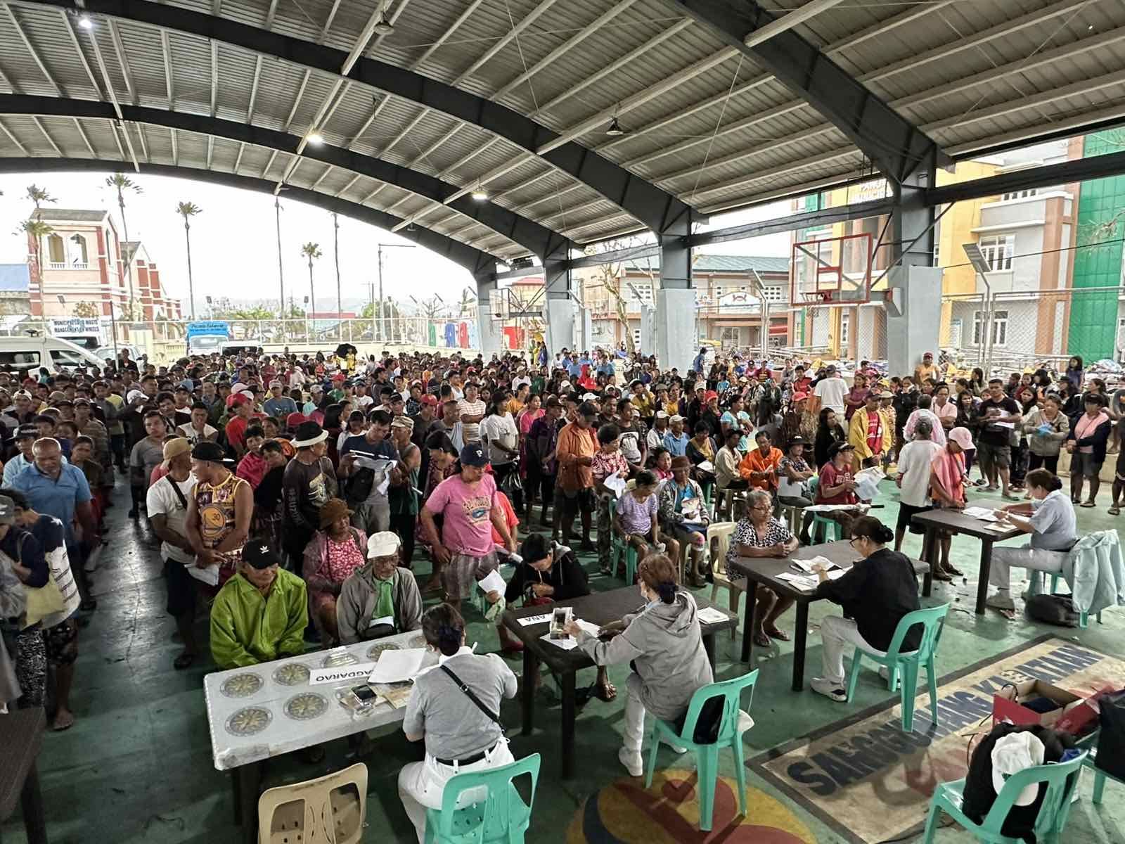 Residents from Panganiban, Catanduanes gather at their local covered court to claim their relief stubs from Tzu Chi volunteers. 