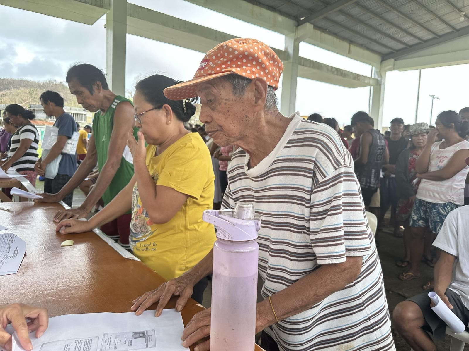 In Gigmoto, residents line up in an orderly fashion during the release of their claim stubs. 