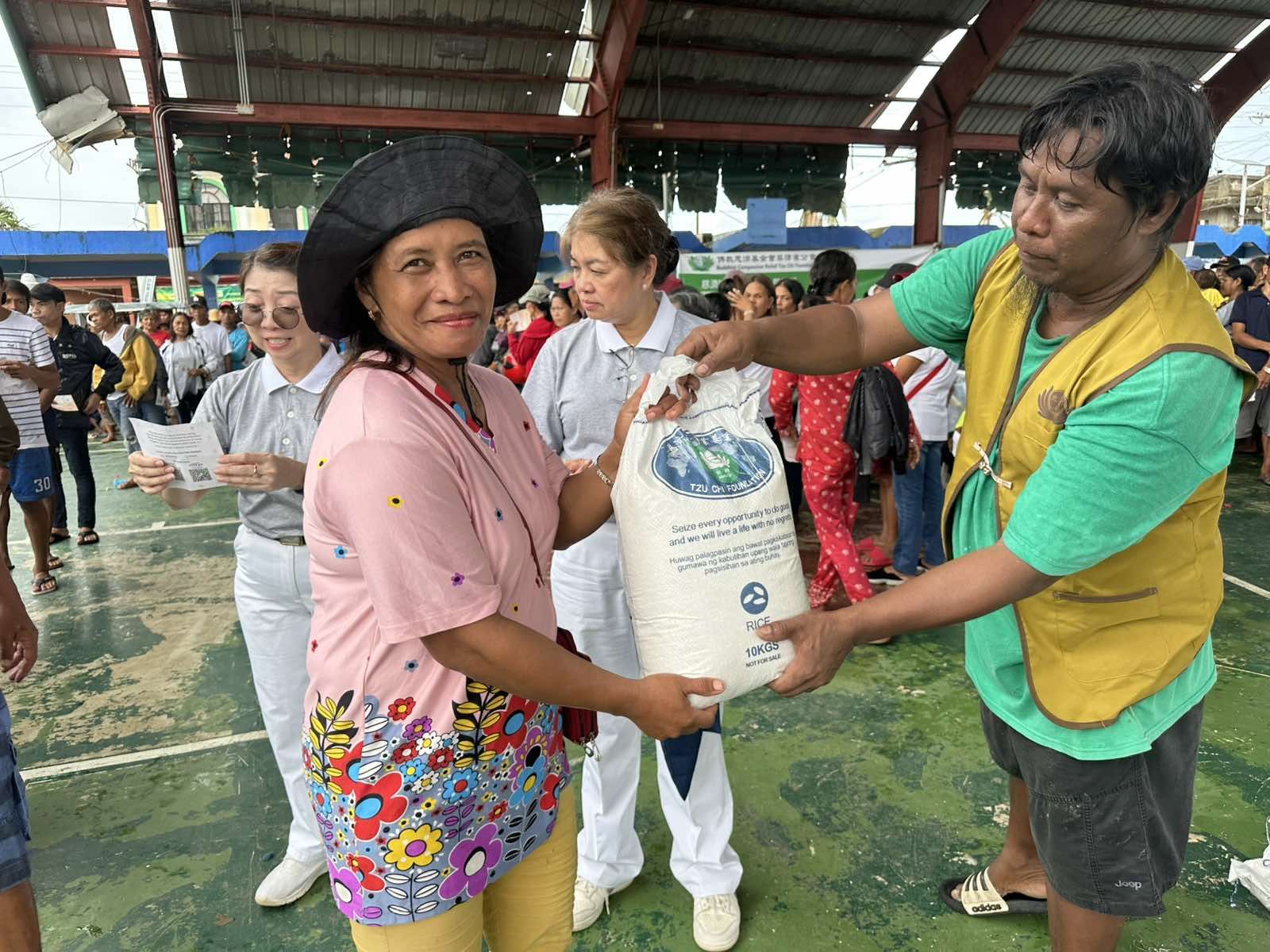 A woman from Viga claims her 10-kg sack of rice. 