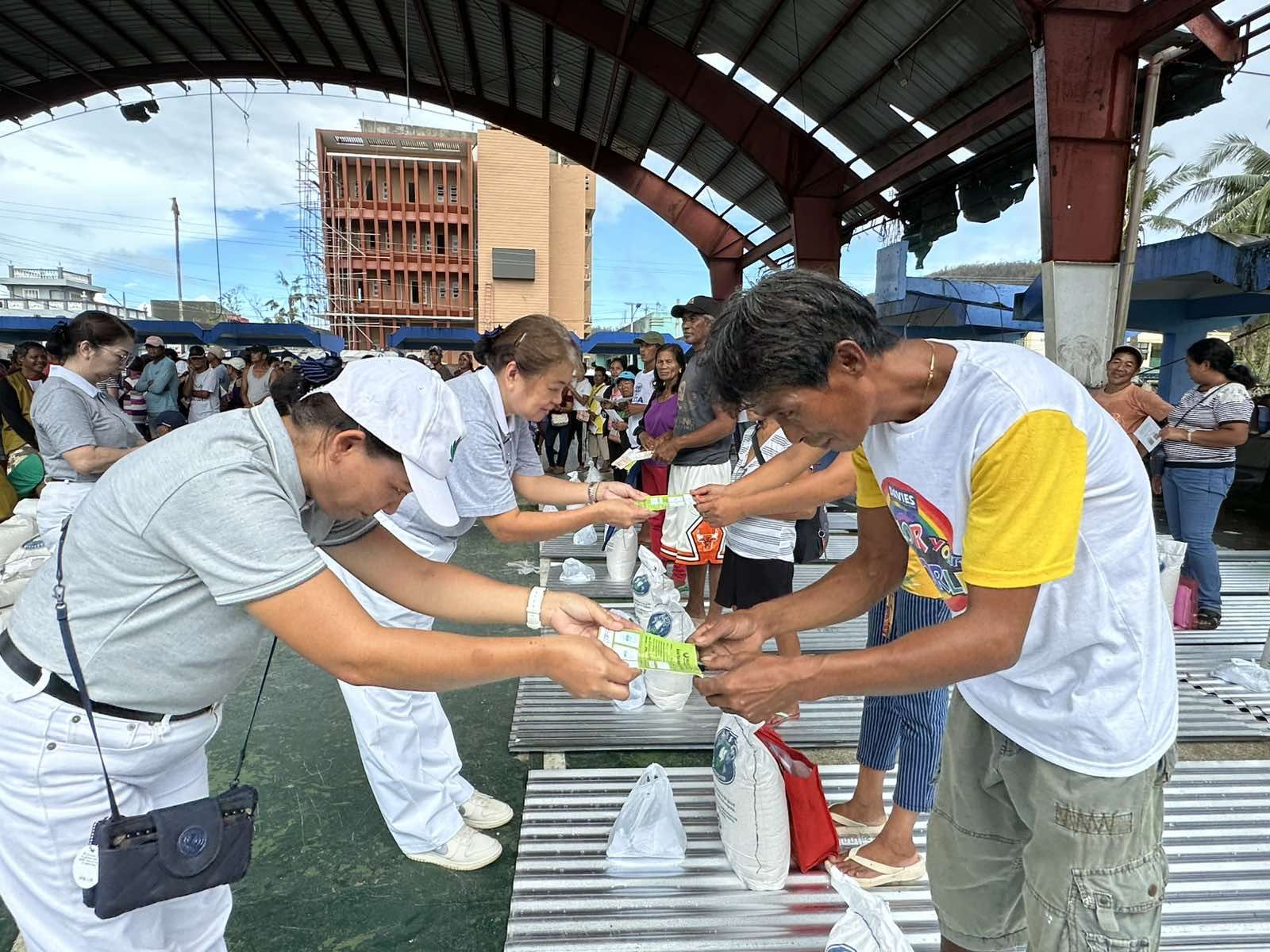 Families with totally damaged homes each received 10 pieces of 10-ft galvanized iron (GI) sheets, a kilo of umbrella nails, and a 10-kg sack of rice. 