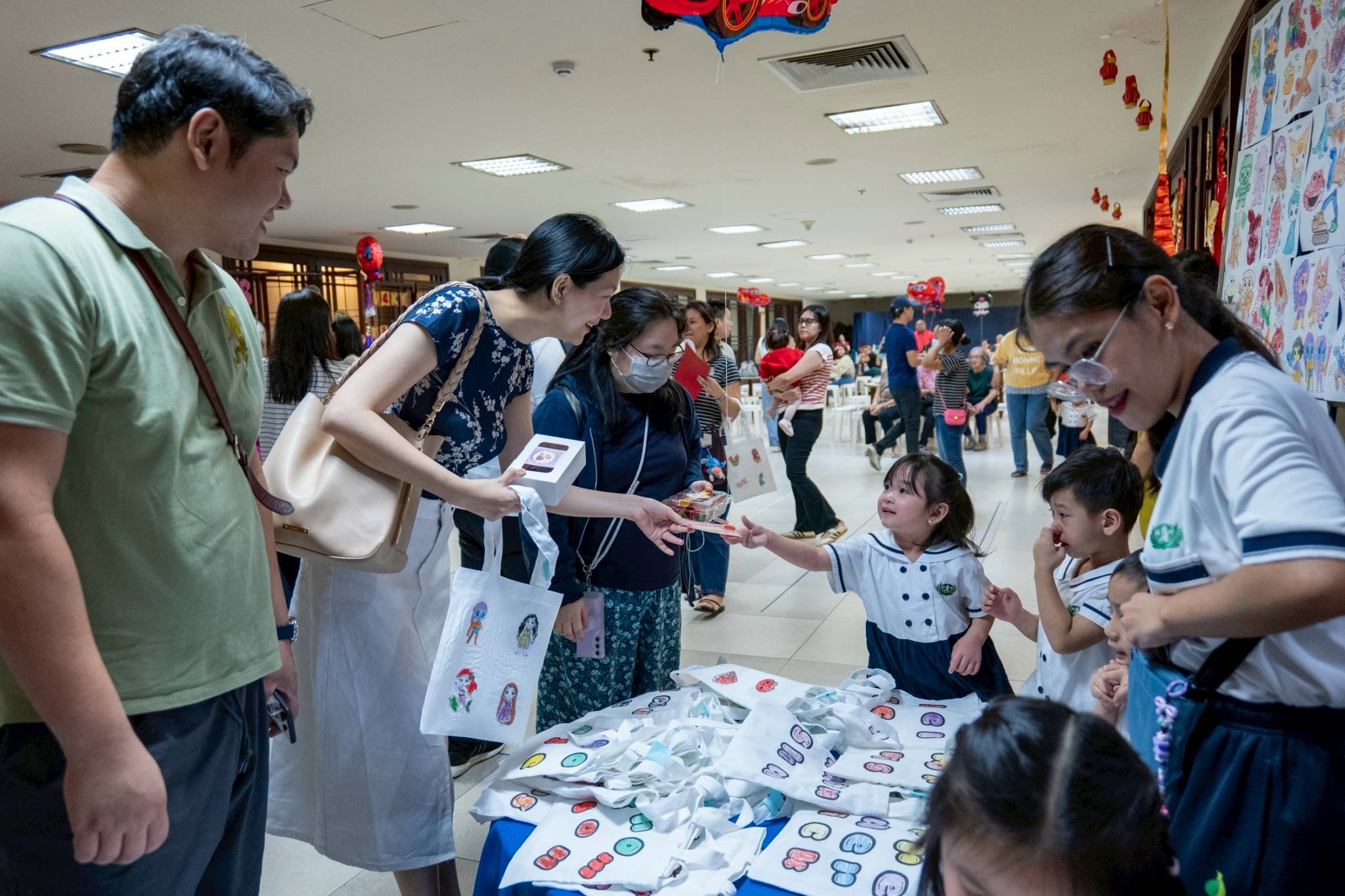 Parents eagerly visited the stalls, selecting from the treats and crafts on display.