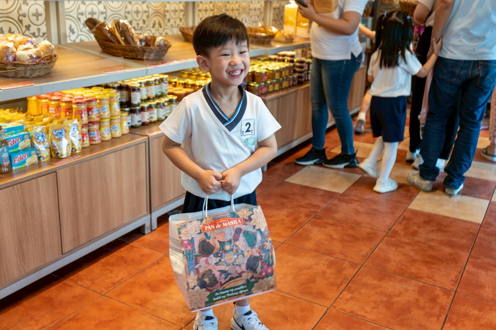 Smiles fill the breadshop as the children personally choose the bread they will bring home.
