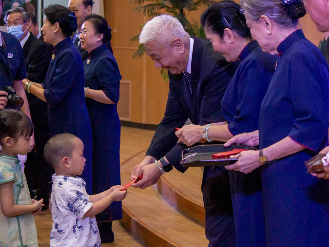 In a gesture of blessing, Tzu Chi Philippines CEO Henry Yuñez distributes angpao, a special red envelope from Dharma Master Cheng Yen containing thoughtful messages, symbolic seeds, and commemorative coins.