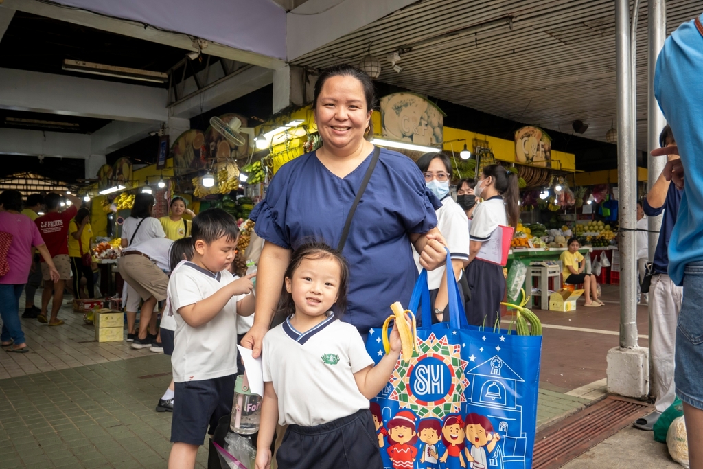 Nikki Ngo (in blue) poses with daughter Naiya after completing their shopping trip.