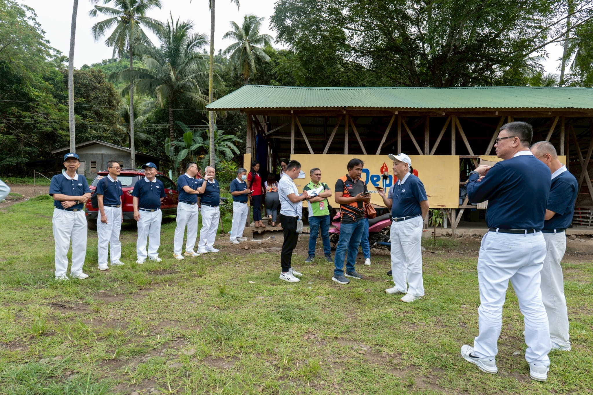 VBLIS Principal Peter Lito Piquero (in black and orange shirt) welcomed the volunteers and led them on a tour of the severely damaged campus.