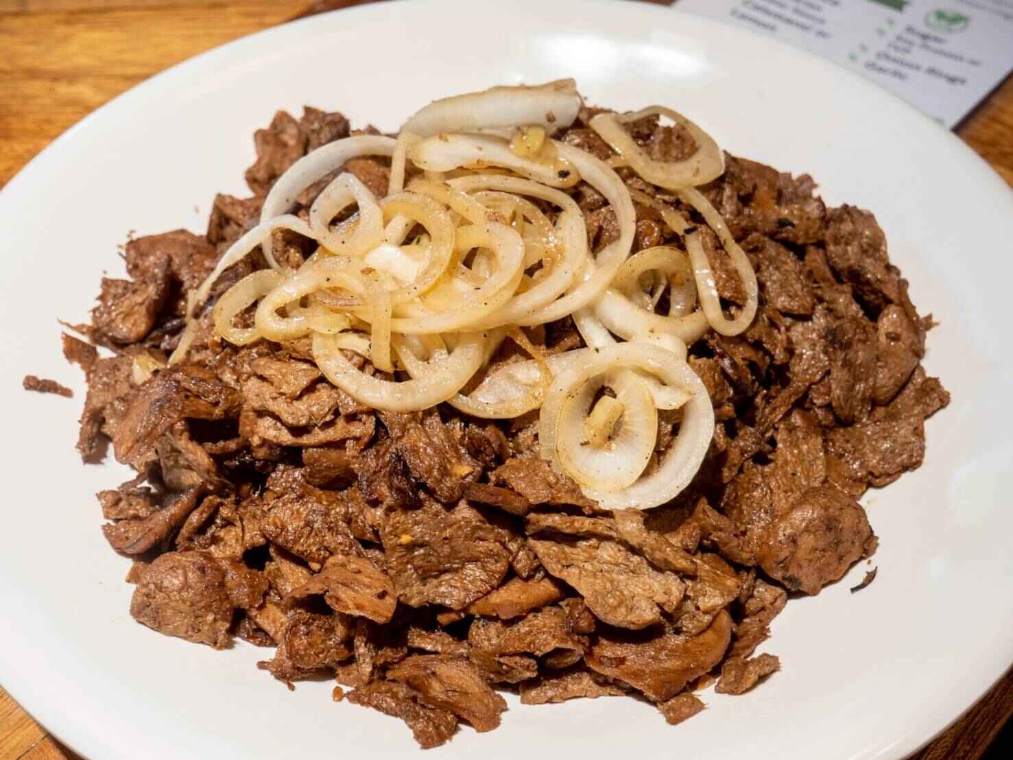 Another crowd favorite, bistek Tagalog is zesty marinated TVP topped with crisp, fresh onion rings. 