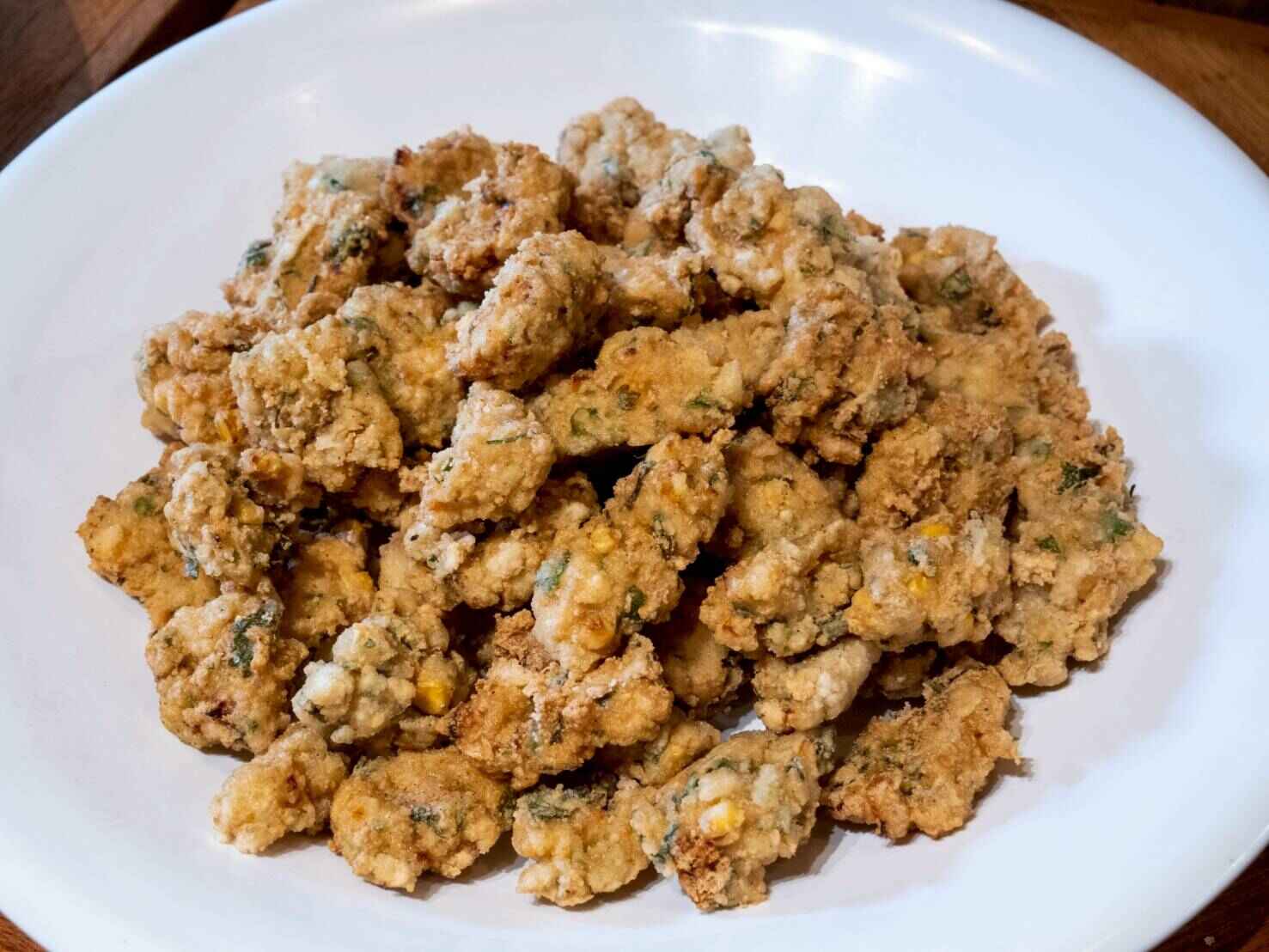 Sweet & sour tofu fritters are crispy golden textured vegetable protein (TVP) and tofu patties tossed in a vibrant, tangy, sweet and sour sauce with a colorful medley of bell peppers and pineapple. 