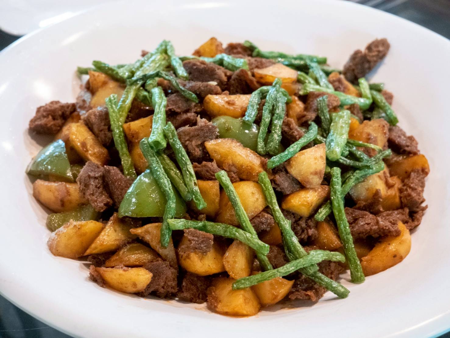A crowd favorite, salpicao features TVP, green beans, and potatoes sauteed with garlic and a flavorful blend of spices. 