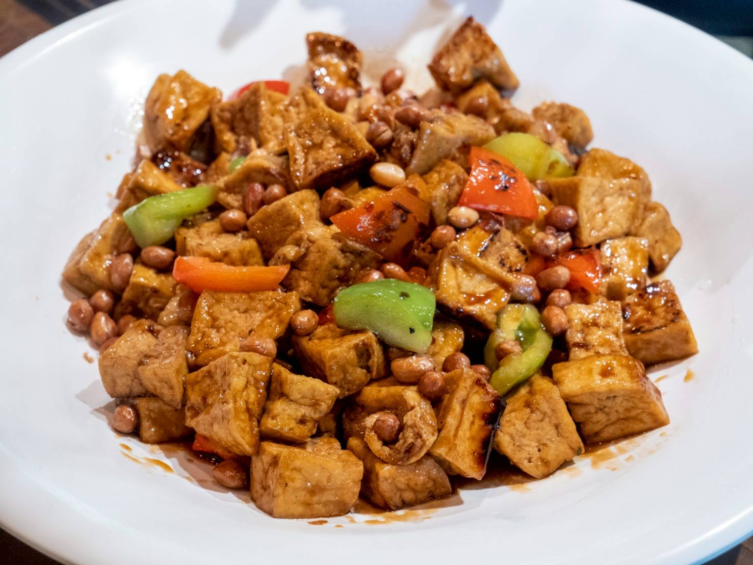 Kung pao is crispy tofu tossed with nuts, veggies, and a spicy savory sauce.