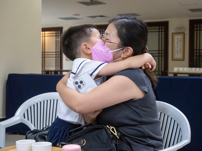 Ching Ching Wong (Right) embraces her son Nathan. 