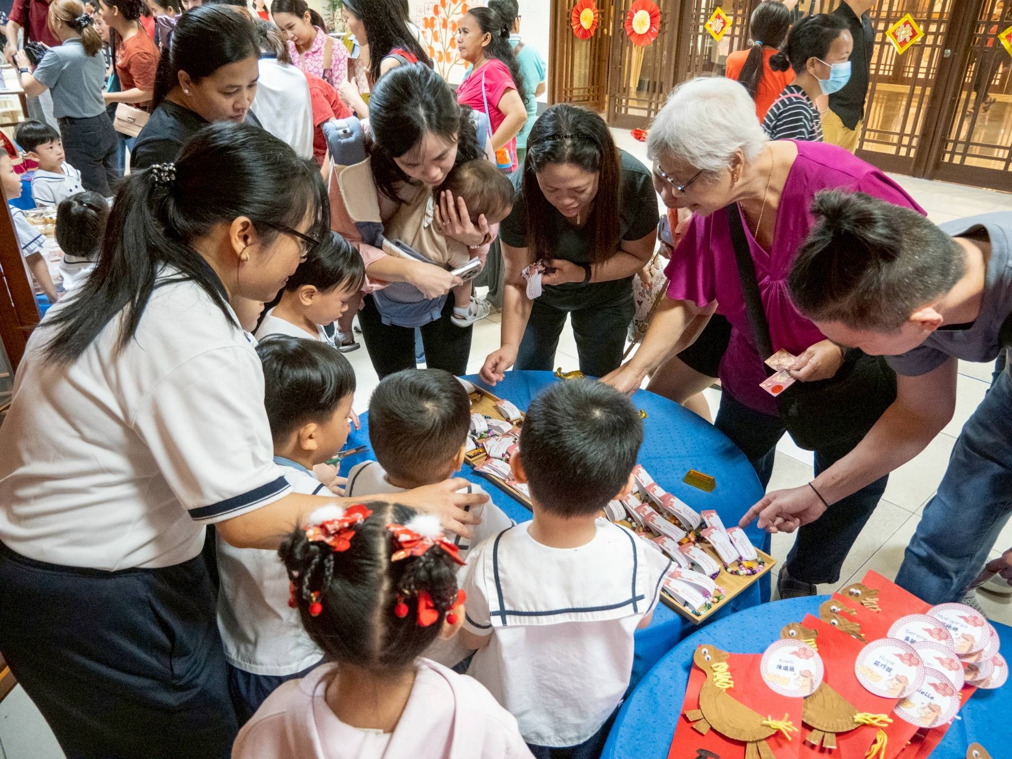 Parents eagerly visited the stalls, selecting from the treats and crafts on display.