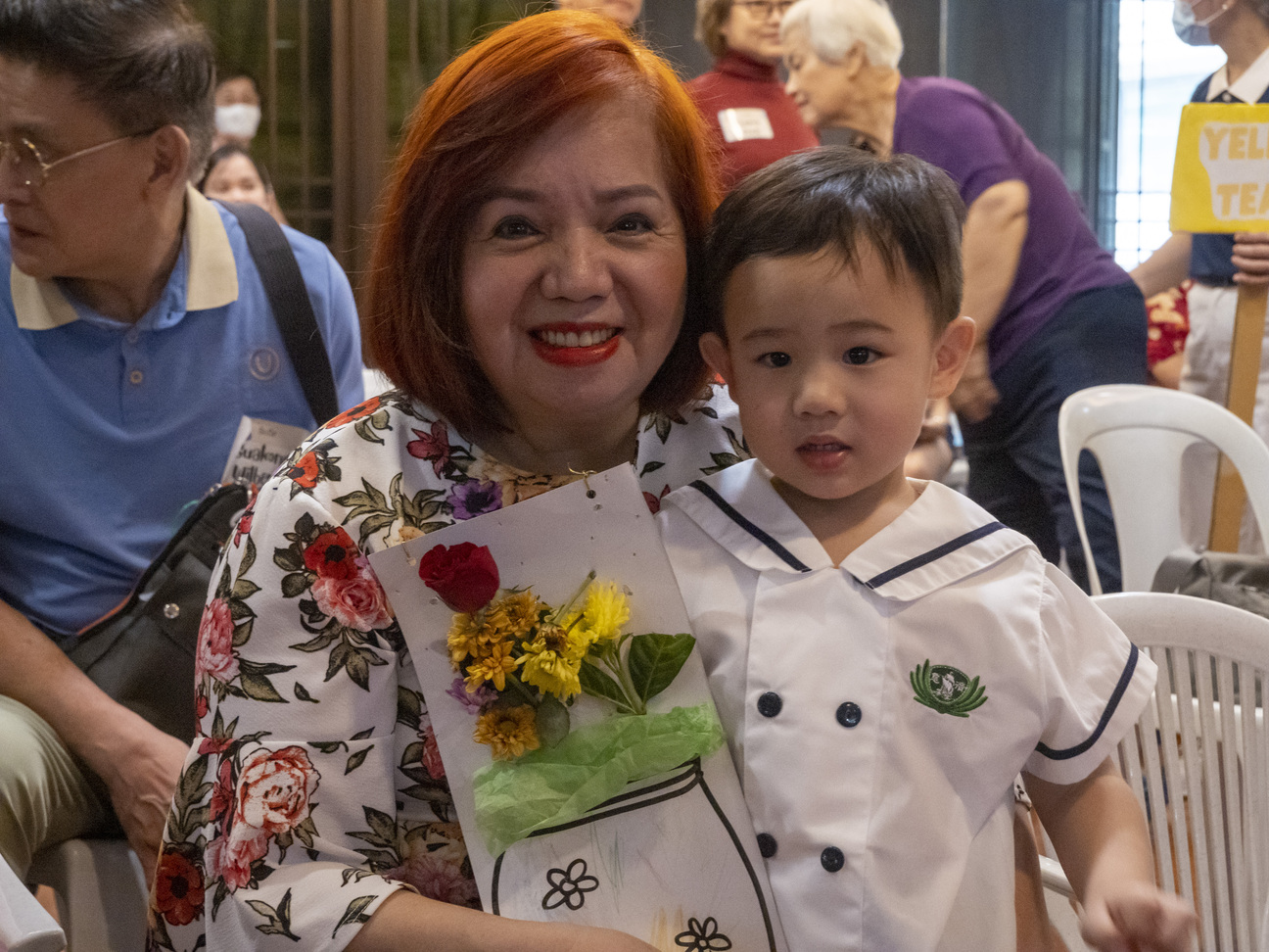 A proud grandparent poses with her grandson and his work of art.