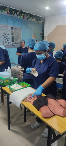 With all the knowledge from her course, Venus Telecio (in front) is vigilant in conducting caregiving simulations.