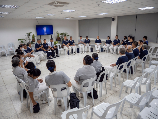 Camp participants form a circle in a group discussion with Kaohsiung commissioners.