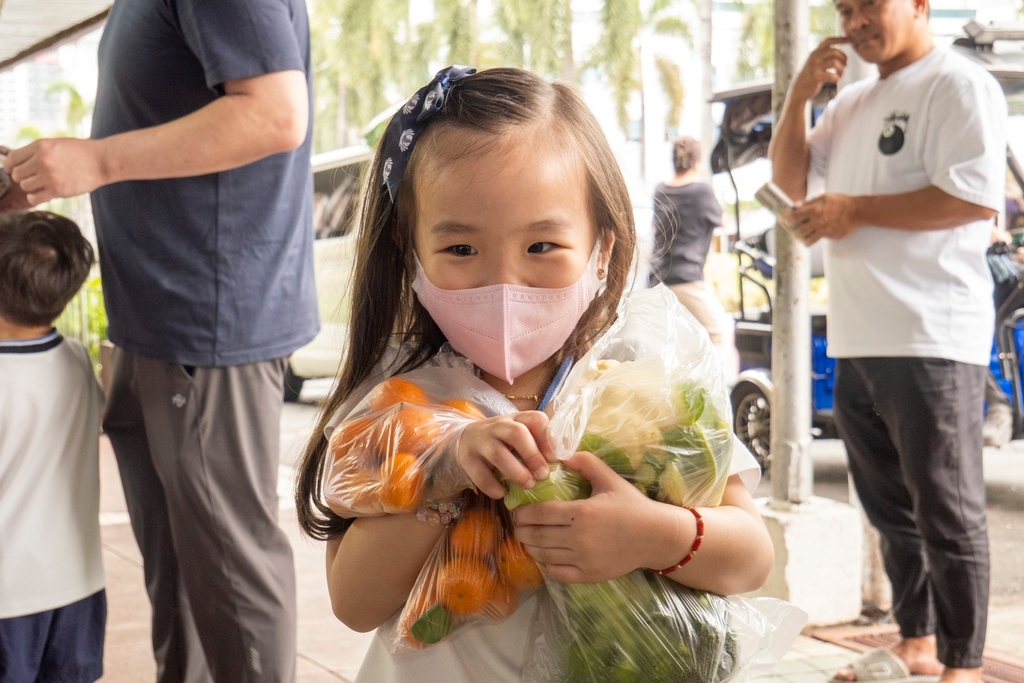 A happy student carries her purchases.