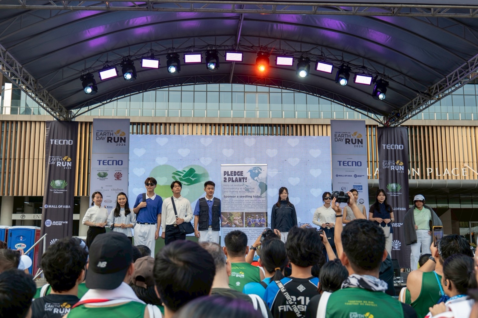 Tzu Chi Youth models gather for a group photo following a fashion show featuring products from DA.AI Technology. 