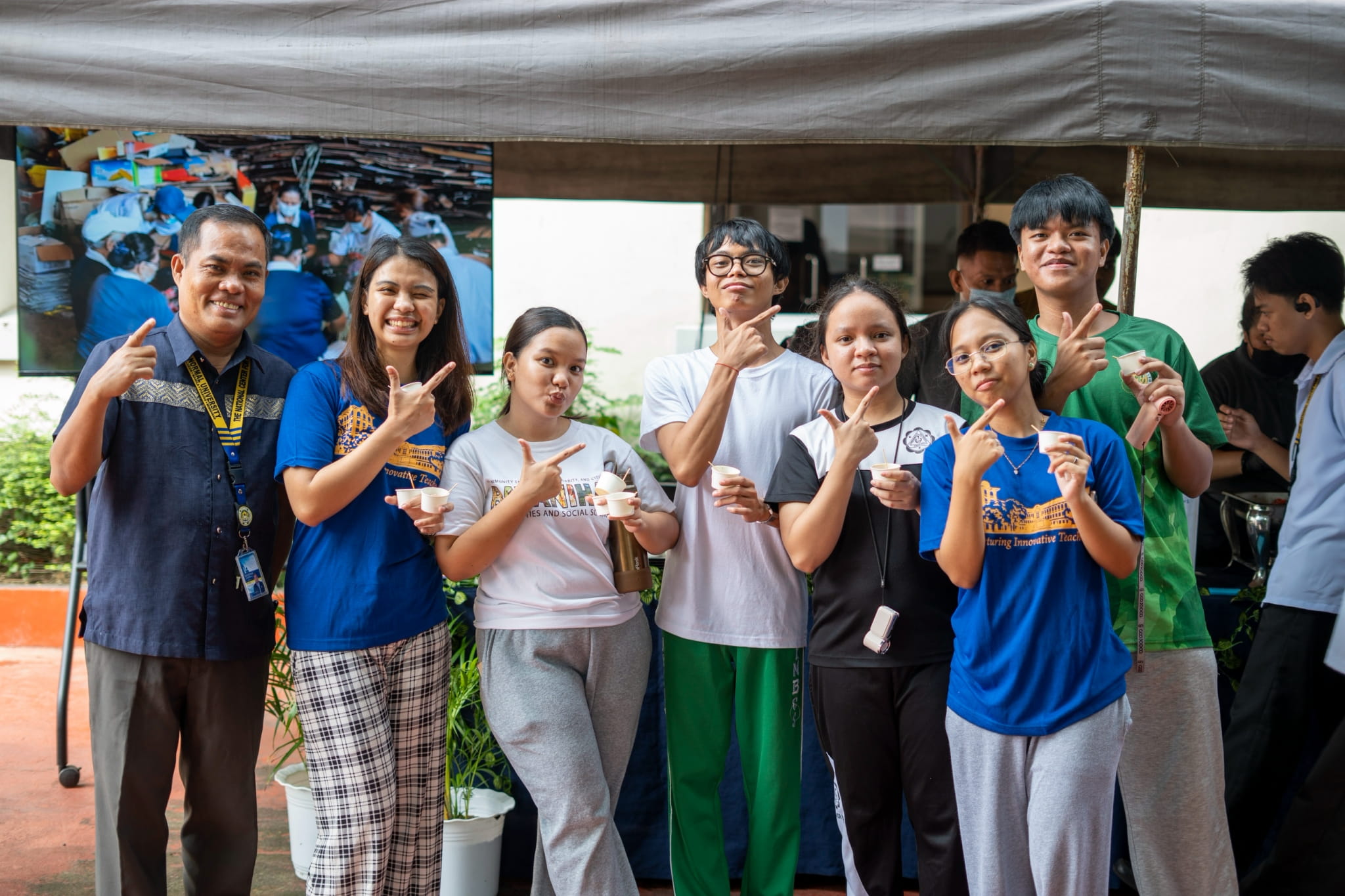 Joseph Luceño, director of Auxiliary Services and Business Development at PNU (first from left), takes a photo with the students who were pleased with the plant-based viands.