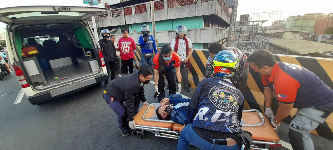 First responders take Dionesio Austero (on stretcher) to the hospital after a car cut in front of him and his motorcycle. He suffered two broken legs, which were thrown over his shoulders./ Photo courtesy of Rosevic Austero