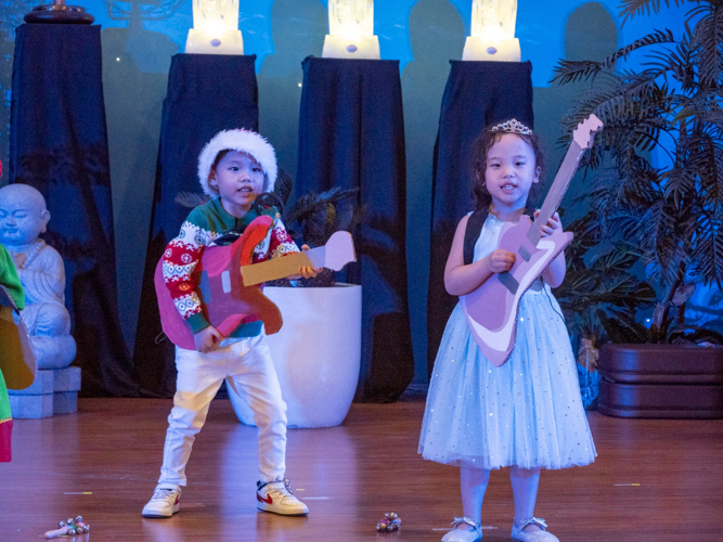 Harper Tan (right) performs a rock Christmas carol for her family.