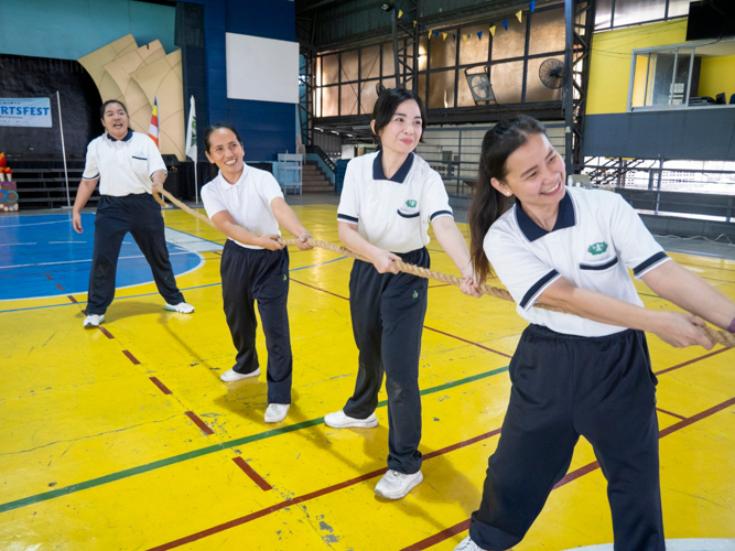 Teachers and staff members also participate in the tug-of-war.