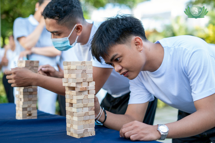 A camp tour becomes more lively when games are involved. At the Abode, scholars are challenged to keep a Jenga tower from toppling.